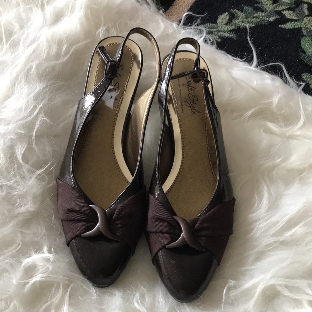 Really cute pair of sling back chocolate brown patent leather shoes with bows